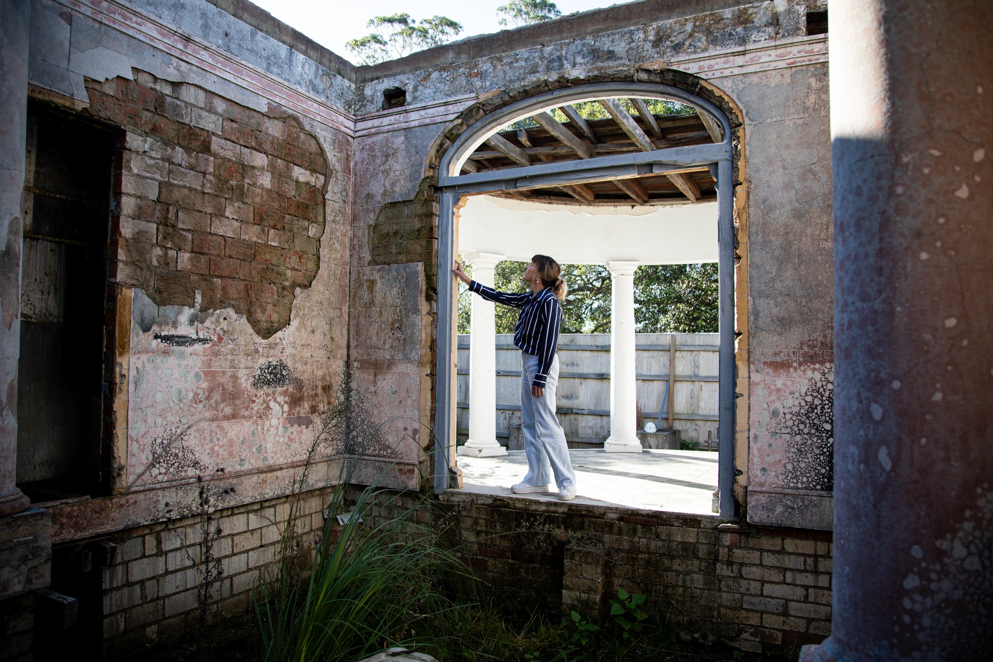 Designer Allison Burrows inspecting the gutted interior of Awaba House prior to reconstruction.jpg