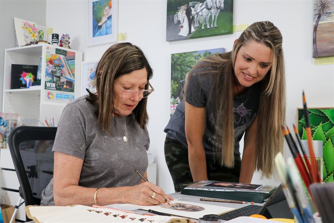 Artist Hayley McLachlan working with Barbara McKenzie in an art workshop at her Morisset studio.jpg